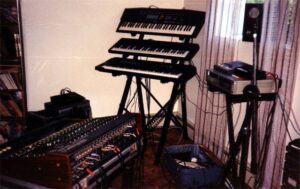 stack of synthesizers with sound board
