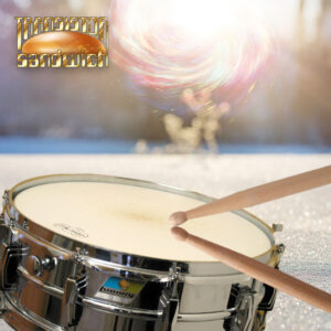 drum sticks on a snare drum in a snowy field