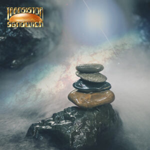 stones piled up on a rock protruding from rapid waters